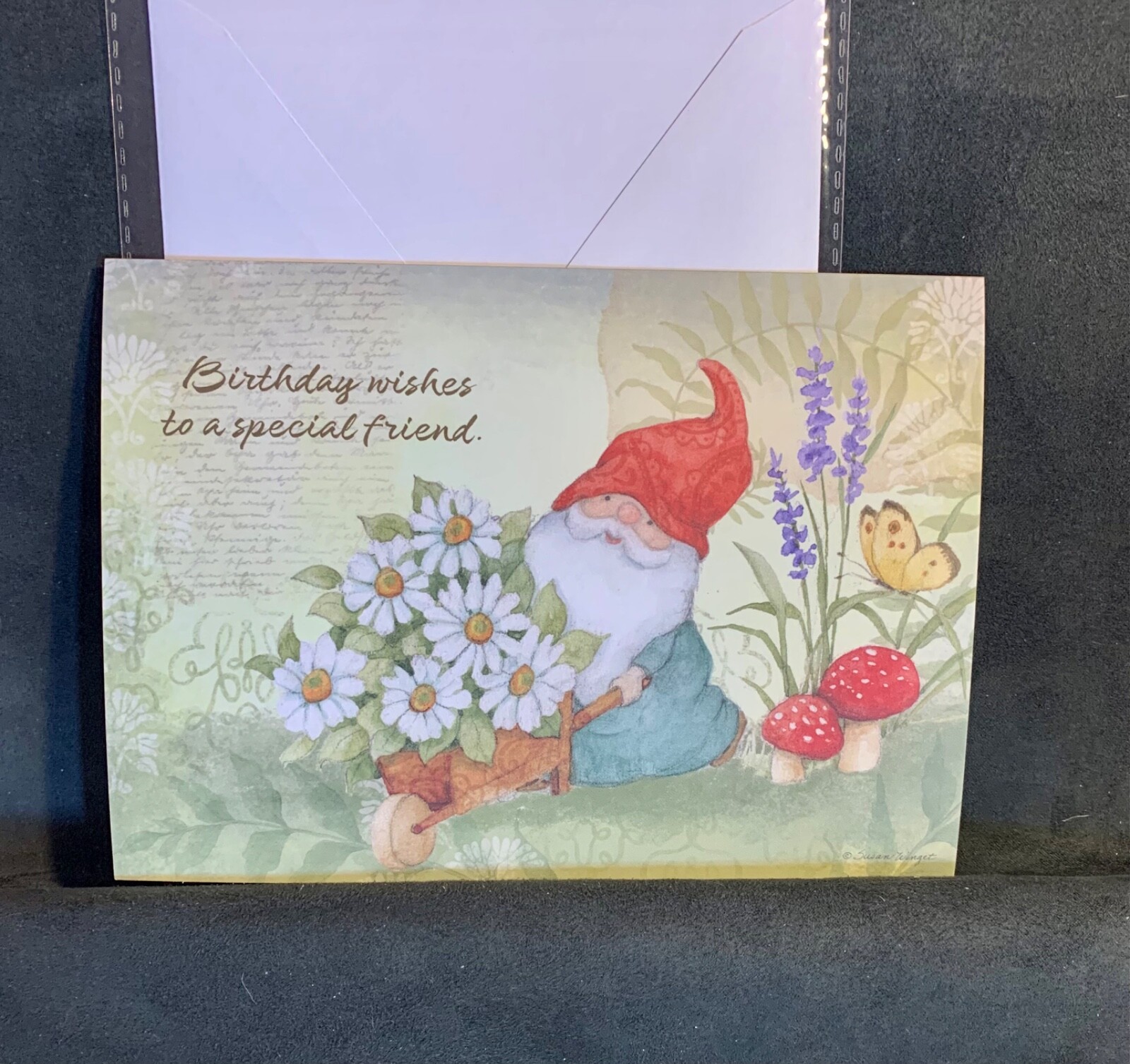 Birthday Card Gnome in Garden with Wheelbarrow of Daisies by artist Susan Winget