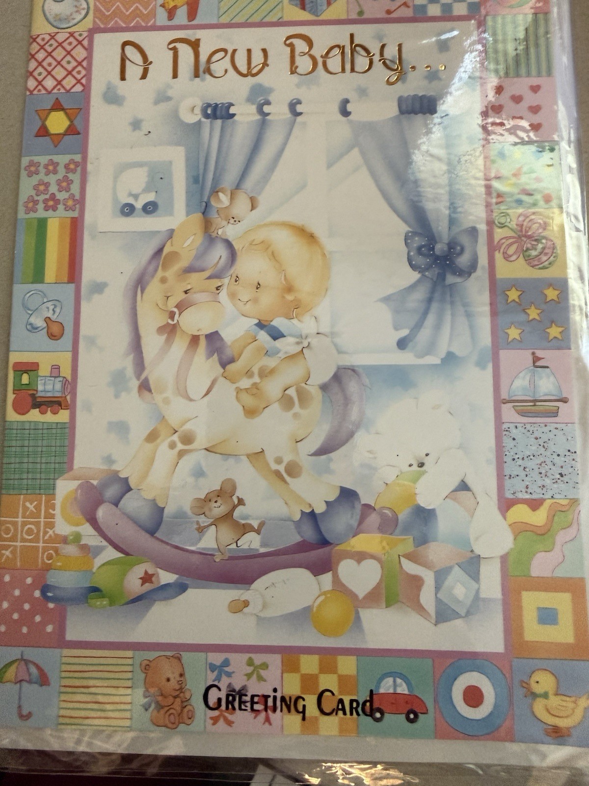 “A New Baby!” – baby on a rocking horse – approx 5.75″ X 8″