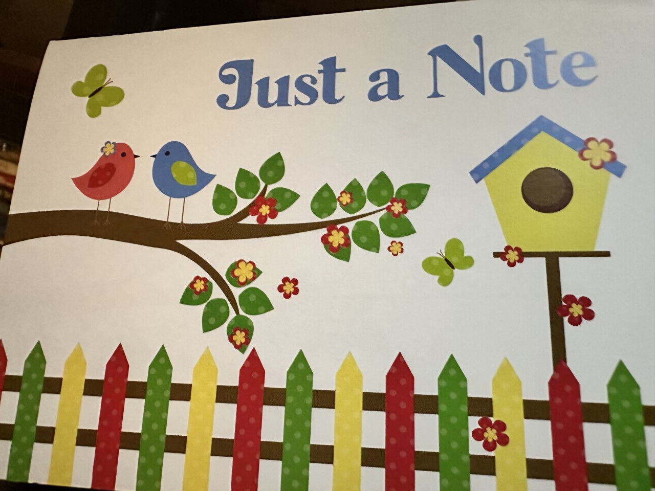 “Just a Note” – Birdhouse with birds in a flowering tree –